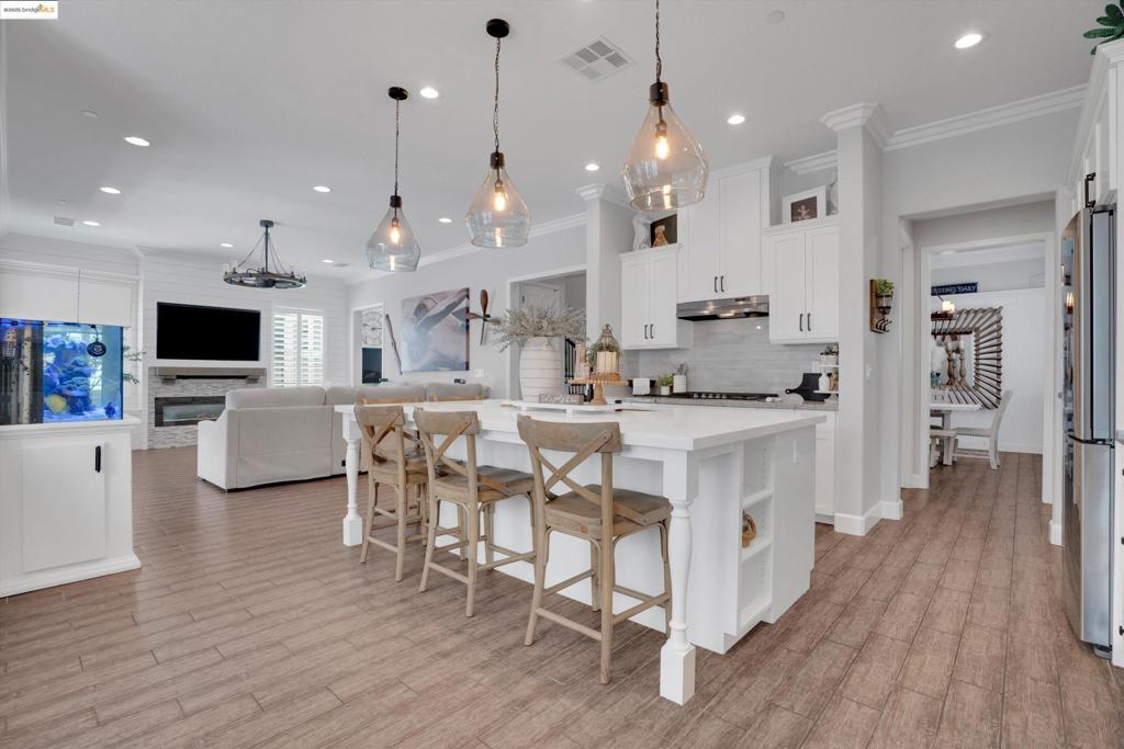Welcome to one of the Most Exclusive and Beautifully Upgraded Homes in Discovery Bay's Premier gated community — THE LAKES. Built by Kiper Homes, one of the area’s most Respected Builders, this residence is part of the Ultra-Limited Anchor Pointe Collection, which includes Only 42 of the 1,206 homes in the Entire Community. Built in 2016, this home showcases one of Kiper’s most sought-after floorplans, designed for both Comfort and Luxury. The Stunning Owner’s Suite is a Private Retreat featuring a Spa-inspired bathroom with Double Walk-In Closets, Elevated Finishes, and a Calming Ambiance. A Spacious Downstairs Bedroom with its own En-Suite provides excellent flexibility for guests or multigenerational living. Entertain in Style with a dedicated media room and a Custom Upstairs Bar within the Open Loft — perfect for movie nights or hosting friends. Step outside to your personal Backyard Oasis featuring a Pebble Tec In-Ground Pool, an inviting California Room with built-in gas fireplace, and plenty of space to Relax or Entertain. This home sits in a Prime Location within the community, just steps away from the neighborhood park, kids’ playground, and pickleball courts. This is a rare chance to own one of the exclusive 42 Anchor Pointe Homes — a True Standout in Discovery Bay.