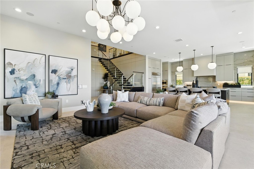 Pinnacle at The Summit at Orchard Hills by Toll Brothers – Homesite 0021. Discover elevated living with the Farlow floor plan, Italianate exterior, 5 ensuite bedrooms, 5.5 baths, and approx. 4,646 sq. ft. on a 6,204 sq. ft. homesite with pool-sized backyard and 2-car garage. Situated on a rare single-loaded street with no direct front or rear neighbors, this home offers privacy and sweeping city-light views toward Newport and Catalina Island. Designed with modern luxury in mind, highlights include a cantilevered steel floating stair with glass railing, 22’ foyer, additional chef’s prep kitchen, conservatory, downstairs suite and office, loft, 60” Primo fireplace, Wolf® and Sub-Zero® appliances, spa-inspired primary bath with Kohler® digital shower system, floating vanities with LED lighting, and a private primary suite deck. Estimated completion is Summer 2026, offering a limited opportunity within Irvine’s premier staff-gated hillside community. Residents enjoy resort-style amenities including saltwater pools, parks, and access to acclaimed Irvine schools. Buyers still have time to personalize select finishes. Photos are of the model home; actual home is under construction.