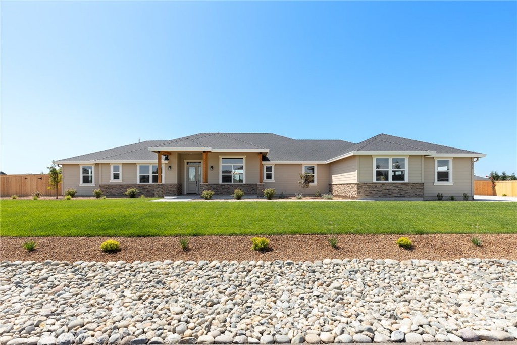 Built with impeccable craftsmanship and designed with exceptional attention to detail, this brand-new home is sure to capture your heart the moment you arrive. From the moment you step through the front door, you’re welcomed by timeless elegance and modern design. The interior boasts stunning laminate flooring, freshly painted neutral walls, and an abundance of windows that flood the home with natural light. The open-concept layout seamlessly connects the living spaces, and the impressive floor-to-ceiling stone fireplace serves as a stunning focal point in the spacious living room—perfect for cozy nights in or entertaining guests. The gourmet kitchen is a chef’s dream. Outfitted with sleek painted cabinetry, expansive countertops, stainless steel appliances, a coveted farm-style sink, and a professional-grade 6-burner gas range, it’s a space where culinary inspiration comes to life. The large center island offers additional prep space and doubles as a breakfast bar, while the separate butler’s pantry adds even more storage and functionality. When it's time to unwind, retreat to the luxurious primary suite. This private oasis features generous square footage, an oversized walk-in closet, and a spa-like en suite bathroom complete with dual vanities, a breathtaking soaking tub, and a beautifully tiled walk-in shower. Looking for more space? This home has you covered. In addition to three comfortable guest bedrooms, it also includes a dedicated office with built-in shelving and a versatile bonus room that can be customized to fit your lifestyle—whether that means a home gym, playroom, or media room. Additional features include recessed lighting, stylish ceiling fans throughout, an oversized three-car garage, and a large backyard with a covered patio that’s ideal for outdoor dining and relaxing. Tucked away in a highly desirable neighborhood, this property offers the perfect combination of luxury, comfort, and practicality. Don’t miss your opportunity to make this one-of-a-kind home your own—it’s everything you’ve been waiting for and more!