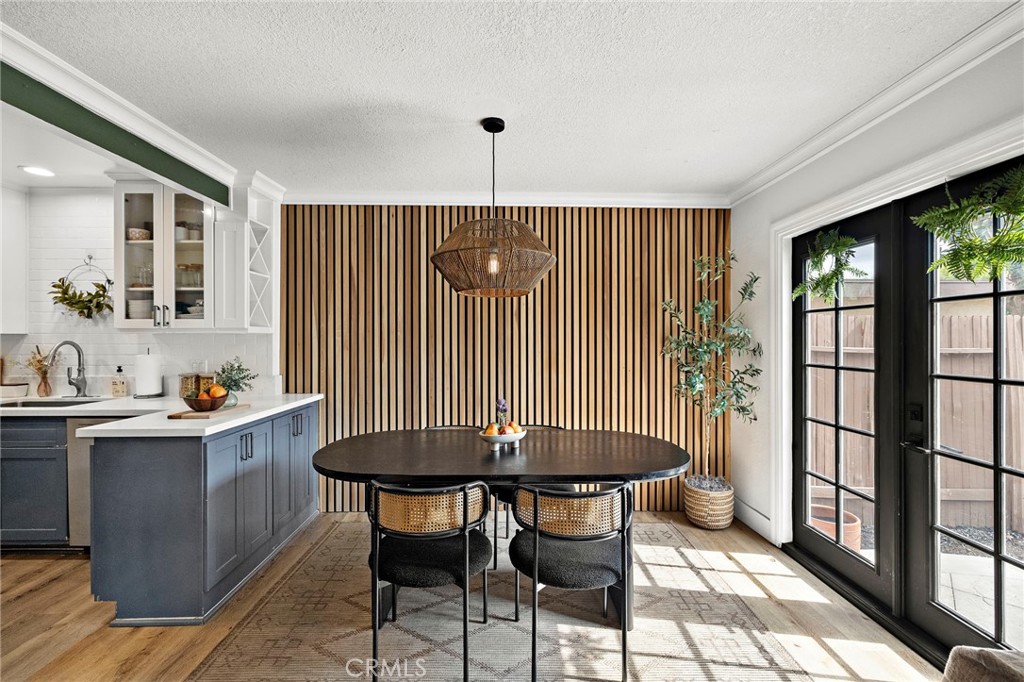 Discover the perfect blend of style and comfort in this beautifully upgraded two-story residence. Located in the desirable Anaheim Hills community, this home offers a modern aesthetic that feels straight out of a magazine.
As soon as you step inside, you’ll be wowed by the stylish home featuring a stunning wood wall that adds character to the downstairs area, while wainscoting in the hallway exudes sophistication. The dining room features a chic light fixture, perfect for at-home dining and hosting gatherings. Enjoy the benefits of a new AC system and new flooring throughout the home, ensuring a fresh and inviting atmosphere. The kitchen features elegant quartz countertops and a new dishwasher, making meal preparation a joy. A new washer is included in the indoor laundry area for added convenience. The living room is enhanced with recessed lighting and a stylish electric fireplace, creating a warm and welcoming ambiance. A custom closet in the primary suite provides ample storage, ensuring that every space is utilized efficiently. Step outside to a low-maintenance backyard with lush turf, perfect for entertaining or enjoying quiet evenings outdoors. This home includes an attached two-car garage and access to two community pools, ideal for relaxation and socializing. Situated near top-rated schools, scenic trails, and parks, this property is perfect for families and outdoor enthusiasts alike.
Don’t miss the opportunity to make this designer home your own, it’s the ultimate combination of luxury, comfort, and convenience.