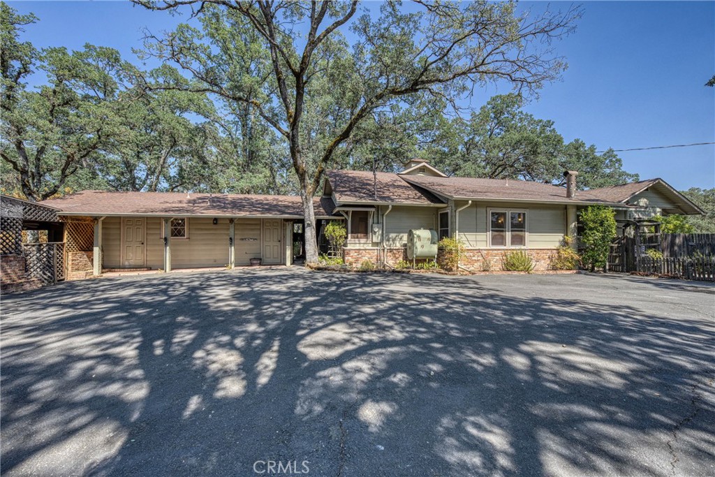 Charming, spacious, and full of character—this unique downtown Lakeport property offers a 2 bed, 1 bath main house plus a 1 bed, 1 bath Jr. ADU on approximately 1.7 acres with beautiful lake views. The main home features an updated kitchen with high-end finishes, including a double oven, wine fridge, and ample counter space—perfect for those who love to cook and entertain. A cozy office provides the ideal work-from-home setup, while the spacious living room invites you in with a fireplace and floor-to-ceiling windows that frame views of Clear Lake.
The main bathroom includes a deep soaking tub for relaxing at the end of the day. Charming original details are thoughtfully blended with modern upgrades throughout the home. Outside, the property shines with a large circular driveway, a detached 2-car garage, 2 carports, and 2 generous workshops—ideal for storage, hobbies, or creative projects. A fenced garden area and separate fenced backyard offer space for pets or gardening, all with a lakeview backdrop. Entertain in style with a covered outdoor kitchen featuring rustic brickwork and loads of character. A rare find offering privacy, versatility, and timeless charm—just minutes from Lakeport’s shops, dining, and waterfront.