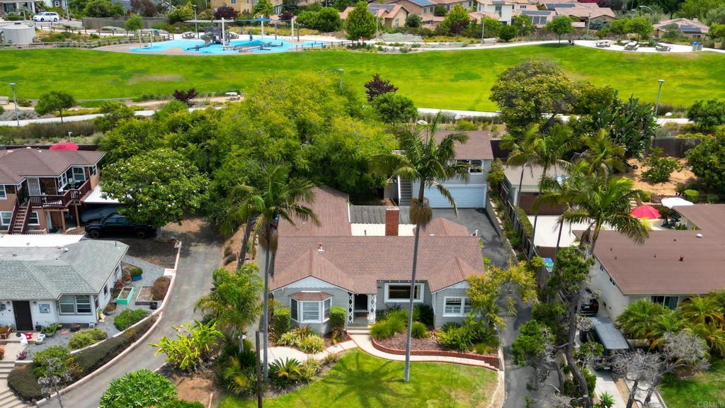 Welcome to Your Timeless Ocean View Craftsman in Olde Carlsbad! Ocean views and coastal breezes await! Coastal living doesn’t get more charming than this! Perched on one of the most prestigious and sought-after streets in Carlsbad, this classic west-facing single-story home is hitting the market for the first time. Originally built in 1941 and lovingly maintained through the decades, the main home offers 2,096 square feet of living space with 3 spacious bedrooms and 2 full bathrooms. Nestled above the detached two-car garage is a beautifully converted ADU—formerly a beloved family bonus room—complete with its own full kitchen and bath, making it ideal for guests, extended family, or rental income. The nearly 10,000 square foot lot features lush, well-manicured front and back yards. A long, private driveway offers generous off-street parking, and here’s a fun local touch: the retaining wall was built using original pieces of the historic Pacific Coast Highway. Enjoy indoor-outdoor living year-round with a covered patio off the kitchen and family room—perfect for entertaining. Start your day or unwind in the evening on the charming front patio, where coastal breezes and sunset views await. The galley kitchen is bright and functional, offering modern amenities and plenty of workspace. Just off the kitchen, a cozy dining nook welcomes natural west-facing light. The great room is open and inviting, anchored by the original fireplace with classic hearth seating. The two secondary bedrooms are generously sized, and the expanded primary suite boasts a walk-in closet and a spacious en-suite bathroom. Located on Highland Drive, this home offers the ultimate lifestyle and location—walking distance to the beach, Carlsbad Village, the lagoon, and the train station. You’ll also be near top-rated schools, parks, the local library, and enjoy easy freeway access for a seamless commute. Don’t miss this rare opportunity to own a piece of Carlsbad’s coastal history!