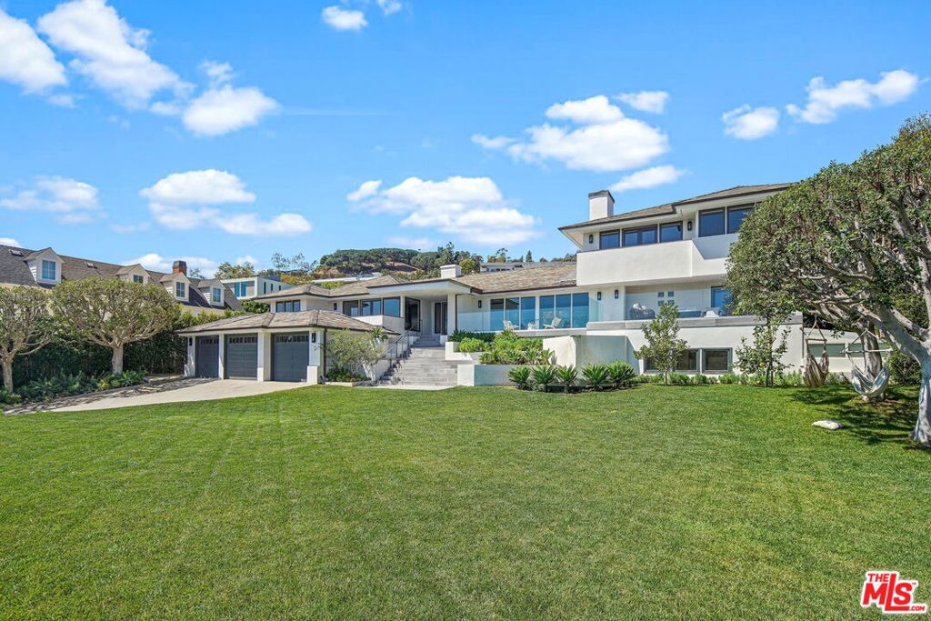Located on one of the most coveted drives within the esteemed Palisades Riviera. Discover this rare clandestine oasis that sits behind gates atop a grassy knoll with stunning panoramic city and ocean views. The majestic home makes waking up in the morning feel like a vacation. Longtime home to an academy award winning director, you'll find it's the ideal space for entertaining and/or relaxing. Having enhanced the timeless architecture with masterful renovations and design developments in 2021, 1655 Amalfi was transformed into a premier establishment for entertaining, offering a media/entertaining room complete with a stage. Enter the charmed cooks kitchen equipped with a commercial sized Viking oven & four stoves. The generously sized lot offers endless amenities like the newly built bar, detached guest house, sparkling swimming pool & spa, in-ground trampoline, rock climbing wall, swing set and expansive grassy front lawn. The spacious Primary Suite extends across 1,255 square feet and offers a secluded sitting area, patio and endless breathtaking views. New Fleetwood sliding doors throughout the main floor allows access to a spacious private viewing terrace overlooking the luxuriant grounds. You will feel as though you've escaped to your own private sanctuary. Easy access to Upper Amalfi hiking and biking trails, Brentwood Country Mart & Caruso Center.