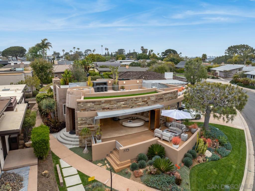Experience the epitome of luxury living with this stunning FULLY FURNISHED contemporary home, just blocks from the beach and the iconic Del Mar Race Track. This one-story home with ocean views on a quiet street was designed for seamless indoor-outdoor living. The front of the home features a dramatic curved sliding glass wall that opens to an inviting front terrace with breathtaking coastal ocean views from La Jolla to the North Coast. At dusk take the party to the rooftop deck to savor the ever changing sunsets, complete with cozy fire pit seating. The beautifully landscaped backyard is a private retreat, offering a built-in jacuzzi and dramatic fire table to dine around, perfect for relaxing evenings under the stars. With high-end finishes and an unbeatable location, this home is a rare opportunity to own a slice of paradise in one of SoCal’s smaller jewel like towns, Solana Beach. Solana Beach may be mini but it maximizes its four square miles by the sea. Emerald green polo fields border the southwest side of town, the bustling Cedros design district and sprawling San Dieguito Park bolster the east, and surfers rule the big blue Pacific waters to the west. Come live in the “Solana bubble” where slower lifestyle rules.