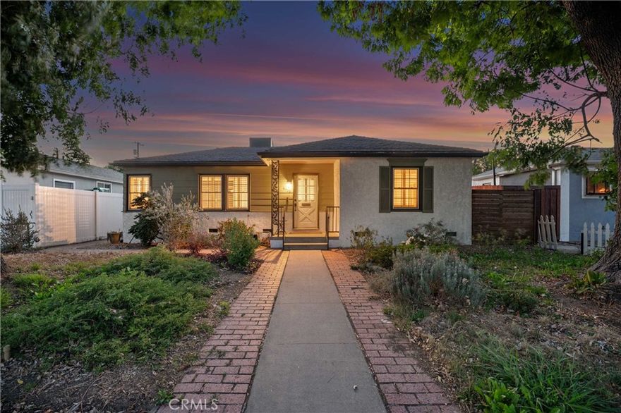 Adjacent to Lake Balboa, is this wonderfully updated 3 bedroom, 1 bath home with a den, a lovely yard and a 2-car detached garage. Possible Accessible Dwelling Unit Opportunity. In addition, it has lovely curb appeal and 2 beautiful Ash trees that provide loads of shade. Central air & forced air heating!! Nest thermostat. Mostly dual pane windows throughout and most of the windows have plantation shutters! Newly painted interior. Mostly copper plumbing! 2 bedrooms and the bathroom have new modern-style doors. Upgraded kitchen, which opens to the den, has tile counter tops, a modern custom cedar plank ceiling, luxury vinyl flooring, new kitchen sink faucet and new water feed lines. Kitchen appliances installed in 2022, include a dishwasher, induction electric cooktop, convection oven & refrigerator. The kitchen closet has a pantry with a stackable washer/dryer, which are included. The den, which is open to the kitchen, has a ceiling fan, luxury vinyl flooring, custom modern cedar plank ceiling, custom built-in shelving and a dual pane glass slider out to the lovely yard. The inviting back yard has lush landscaping, fruit trees, a storage shed & a large custom-built covered patio, which is great for dining Al Fresco. The upgraded full bath has a new vanity, w/new fixtures, upgraded lighting, a tiled tub/shower combo and a tile floor. Both secondary bedrooms with double door closets and plantations shutters. Home network CAT 5 to most rooms. Hardwood floors in the living room, dining area, 1 bedroom and the hallway to the bedrooms. In addition, the living room and dining area have crown molding. The dining area has a built-in wine rack, shelving and an eye-catching light fixture. Back bedroom with crown molding, double door closet, a single door closet, wood paneling, ceiling fan, plantation shutters and a dual pane slider out to the back yard. Front and middle bedrooms both have double door closets and windows with plantation shutters. Automatic sprinklers in both the front and back yards. Additional upgrades: Replaced electrical panel in 2022  & a 100 watt subpanel installed in the garage. The detached garage also has a full length custom workbench, a center custom work station, a French-cleat modular organization system & a mini-fridge. A new sewer cleanout was installed in 2023. Walking distance to Jesse Owens Park. Reseda Park & Recreation Center offers many activities including pickleball courts coming soon.