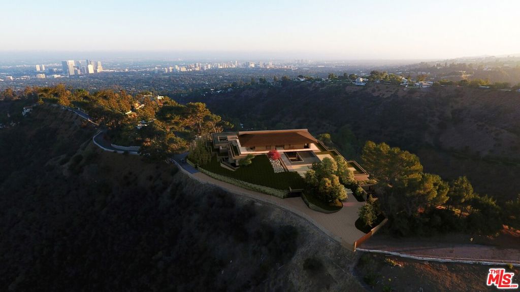 Development Opportunity. A triumph of modern architecture, masterfully conceived by the esteemed Walker Workshop, whose visionary designs have captivated the world. Standing proudly atop a majestic mountaintop, this 17,500 SF residence is an unparalleled work of art, the only one of its kind. Prepare to be mesmerized by the panoramic 270-degree views that stretch as far as the eye can see, with a breathtaking 96' wide opening that provides an uninterrupted vista of the entire Los Angeles landscape. A true marvel of engineering, the structure seems to defy gravity, effortlessly floating above the city below. With a discreet lower level that harmoniously blends into the natural surroundings, this property offers a private sanctuary for those who seek respite from the bustle of city life. Bathed in natural light that spills through the perimeter, the lower level reveals stunning vistas of downtown to the east and the Pacific Ocean to the west. A tropical water garden gracefully cuts through the building, leading to a sunken courtyard that evokes a sense of tranquility and serenity. Every detail has been meticulously considered, resulting in a harmonious balance between nature and architecture that is truly awe-inspiring. This remarkable property can be delivered RTI (permits ready to issue).