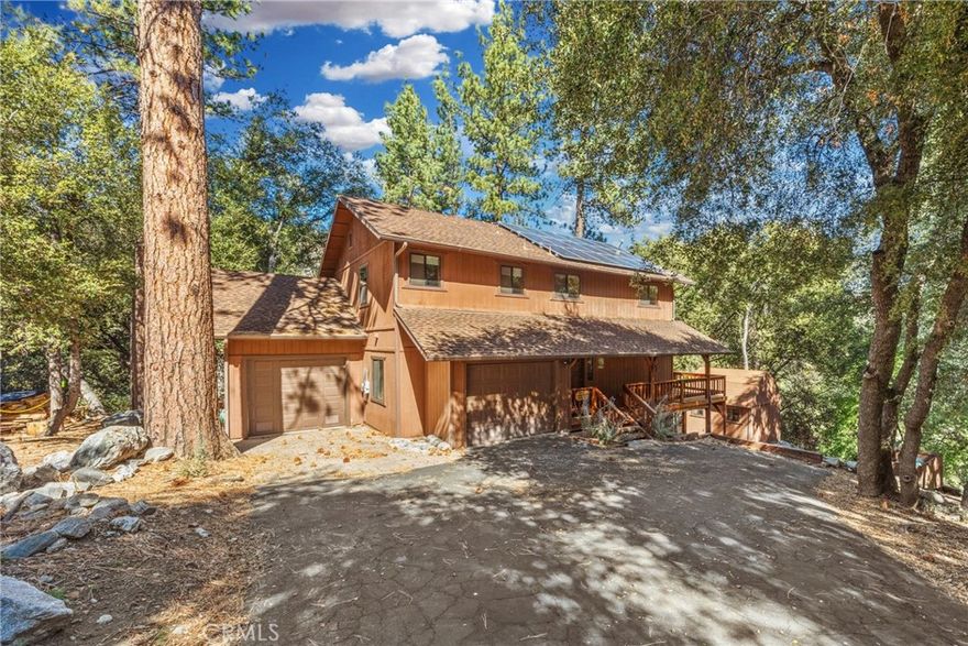 At the very end of a quiet cul-de-sac, 2332 Alpen Court sits against the greenbelt, offering unmatched privacy and peaceful forest views. With over 1,000 square feet of wraparound decking, this home was designed to take full advantage of its secluded setting.

The main entry level features two comfortable bedrooms, two full baths, and a convenient laundry area. Upstairs is devoted entirely to the spacious primary suite, complete with a walk-in closet, another laundry space, and an ensuite bath that includes dual sinks and a Jacuzzi tub with a shower. A slider off the open living, kitchen, and dining areas leads directly to the back deck—perfect for enjoying coffee among the trees or hosting summer evenings outdoors.

On the lower level, a flexible space expands the possibilities. Here you’ll find a large room previously used as a quilting studio, another room ideal as an office or hobby space, plus a full bathroom. Two one-car garages and a flat driveway add everyday ease to the mountain lifestyle.

Life here includes more than the home itself. Ownership in Pine Mountain Club means access to the community’s Olympic-style pool and spa, tennis and pickleball courts, golf course, equestrian center, and clubhouse activities—along with year-round essentials like road maintenance, snow removal, trash service, and 24/7 patrol. For added peace of mind, Kern County Fire Station 58, complete with paramedics and a helipad, is located right in the community.

With its rare cul-de-sac location, direct greenbelt access, and versatile floorplan, this home offers both privacy and room to grow—whether you’re seeking a quiet retreat, a full-time residence, or a place where hobbies and home life can thrive together.