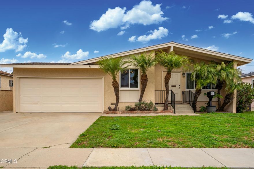 Mid-century California coastal-inspired single-story home showcasing a clean stucco exterior, iconic low-pitched gable roof, and wide overhangs that reflect classic West Coast design. Located in the heart of Midtown Ventura, this home offers a relaxed coastal lifestyle with the convenience of a central, walkable neighborhood. The living and dining areas showcase classic mid-century character with open, light-filled spaces and architectural detail throughout. The living room features exposed beam ceilings, warm hardwood flooring, and a ceiling fan with light, creating a comfortable and inviting gathering space. Neutral wall tones enhance the sense of volume, while natural light highlights the wood floors and clean lines. Updated kitchen featuring warm wood raised-panel cabinetry with crown molding, polished granite countertops, and a full-height linear glass tile backsplash. The space is anchored by durable porcelain tile flooring laid in an offset pattern and complemented by stainless steel appliances, including a gas cooktop, built-in oven, microwave, refrigerator, and dishwasher. A double-basin sink with a commercial-style pull-down faucet sits beneath a large window, filling the kitchen with natural light. Recessed lighting, neutral wall tones, and a functional galley layout create a clean, cohesive, and move-in-ready kitchen with timeless appeal.The backyard offers a private and functional outdoor setting with a spacious paved patio ideal for outdoor dining, entertaining, or lounging. Concrete pavers with brick inlay create defined gathering areas, while raised planter beds and mature trees add greenery and character. A grassy lawn provides space for play or pets, all enclosed by perimeter block walls for privacy. Midtown is known for it's mid-century charm, and easy access to Ventura's beaches, downtown, and harbor. Residents enjoy quick trips to local coffee shops, neighborhood parks, and everyday essentials, along with a short drive or bike ride to the sand, Pierpont, and Ventura Pier