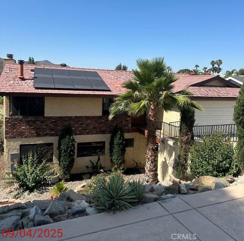 Canyon Lake home with 4 bedrooms 2.5 baths, 2-car garage. Main entry is at street level and is the main living space with wood floors, kitchen has granite counters, tiled flooring, half bath, garage access and side door and slider that open to your covered balcony with hillside views. The stairs that lead to the bottom patio and backyard. Downstairs has 4 bedrooms, 2 baths, separate laundryroom, wet bar, living area with a fireplace. Home also has a whole house fan, washer/dryer and fridge, downstairs has new carpeting and New AC unit, owned solar. Canyon Lake has controlled access with a 24/7 guarded gate, community events, alake, equestrian center, a private beach, parks, and picnic areas. There is also a golf course, tennis courts, and aclubhouse that offers recreational activities such as fitness classes, concerts, and events. ALL THE INFORMATION DEEMED RELIABLE BUT NOT GUARANTEED. AGENT AND BUYERS TO PERFORM DUE DILIGENCE IN RESPECT TO ALLASPECTS OF THE PROPERTY. HOME IS BEING SOLD IN ITS CURRENT AS-IS CONDITION WITH NO REPAIRS.(INLCLUDING APPLIANCES THAT ARE CURRENTLY LOCATED AT THE PROPERTY). SELLER HAS NO KNOWLEDGE OF THEIR CONDITION. SELLER MAKES NO WARRANTIES EXPRESSED OR IMPLIED AS TO ITS CONDITION.