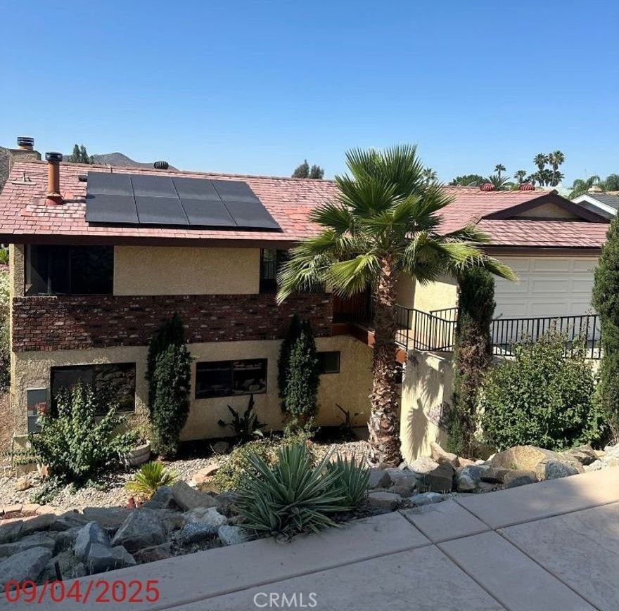 Canyon Lake home with owned SOLAR, NEW AC Unit, and NEW Carpeting in the downstairs area.  Home has 4 bedrooms 2.5 baths, 2-car garage. Main entry is at street level along with the main living shared-space.  The main level has wood floors, kitchen has granite counters, tiled flooring, half bath, garage access and a side door and slider that open to your covered balcony with hillside views.  The stairs that lead to the bottom patio and backyard. Downstairs has 4 bedrooms, 2 baths, separate laundry room, wet bar, living area with a fireplace, and additional dining/den area. Home also has a whole house fan, washer/dryer, fridge.  Canyon Lake has controlled access with a 24/7 guarded gate, community events, a lake, equestrian center, a private beach, parks, and picnic areas. There is also a golf course, tennis courts, and a clubhouse that offers recreational activities such as fitness classes, concerts, and events. ALL THE INFORMATION DEEMED RELIABLE BUT NOT GUARANTEED. AGENT AND BUYERS TO PERFORM DUE DILIGENCE IN RESPECT TO ALLASPECTS OF THE PROPERTY. HOME IS BEING SOLD IN ITS CURRENT AS-IS CONDITION WITH NO REPAIRS.(INLCLUDING APPLIANCES THAT ARE CURRENTLY LOCATED AT THE PROPERTY).  SELLER HAS NO KNOWLEDGE OF THEIR CONDITION. SELLER MAKES NO WARRANTIES EXPRESSED OR IMPLIED AS TO ITS CONDITION.