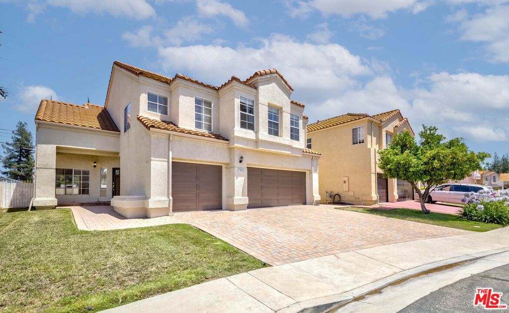 Offered for the first time since it was built, this spacious two-story residence is tucked away in the serene, gated community of La Villa Nueva. Lovingly cared for by its original owner for over 30 years, the home blends timeless comfort with classic charm. A brick-accented driveway leads to a 3-car garage, setting the tone for the refined character throughout. Inside, the open living room welcomes you with soaring double-height windows that flood the space with natural light, highlighting the sleek laminate floors. A dramatic chandelier adds a touch of grandeur, making the space feel both warm and luxurious. The formal dining room features high ceilings and recessed lighting, creating a bright and elegant setting for entertaining. The family room connects seamlessly to the kitchen and opens to a private patioan ideal layout for indoor-outdoor living. The kitchen is designed for both function and connection, featuring bar seating, a center island, and a cozy fireplace that evokes rustic warmth. A grand staircase leads to an open gallery landing upstairs, enhancing the home's architectural interest. On the second level, you'll find three generously sized bedrooms, each with its own bathroom. The primary suite offers a luxurious retreat, complete with a soaking tub, separate shower, private toilet room, and dual walk-in closets. The hallway includes built-in cabinetry for added storage. Well maintained and full of potential, this home offers the perfect canvas for light updates that could make it even more beautiful and truly your own.Located within top-rated school districts Chaminade Prep, Pomelo Elementary, and El Camino Real Charter High this home is also just minutes from UCLA West Hills Hospital, local shopping, and West Valley dining destinations.