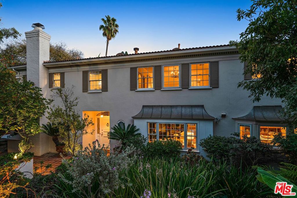 $1M Reduction! Extremely private 1937 Traditional-style estate & guest house on prized, half acre+ parcel. Five bedrooms, 5 baths, lush grounds, oversized pool & spa, mesmerizing views, poised on one of the best streets in desirable Los Feliz! First floor: foyer, powder, library, living, dining, family, kitchen, 2 bedrooms (1 ensuite), bath, gym and laundry. Second floor: 1 guest ensuite, 2 primary suites, each w/steam showers & large spa tubs; large outdoor terrace. Hardwood floors plus premium finishes & fixtures throughout. Outdoors: 2 dining terraces, fully-equipped kitchen, fire pit, sauna, organic vegetable garden (many fruit trees!), greenhouse, enchanting Balinese-style pavilion & more! Two-car garage + covered carport reached via long driveway. Move-in condition. This is a special home, ideal for intimate family gatherings or large group celebrations and awaits its next lucky steward.