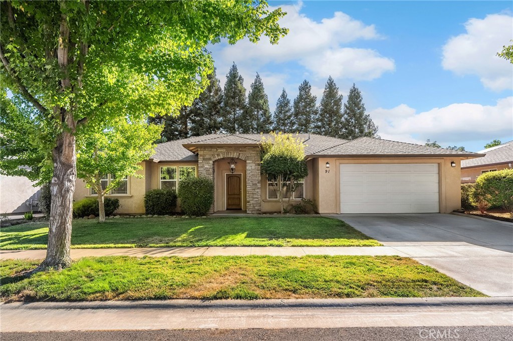 Welcome to 91 Cinder Cone Loop, a stunning North Chico home where thoughtful updates meet timeless comfort. Nestled on a tree-lined street in a desirable neighborhood, this 4-bedroom, 3-bathroom home with a dedicated office spans 2,208 sq. ft. and offers the perfect blend of style, functionality, and retreat-like living. Step inside and you’re greeted by an inviting entryway with a private office just off to the side, perfect for working from home, managing day-to-day life, or a place to study. The heart of the home is the spacious living room, featuring vaulted ceilings, a cozy gas fireplace, a custom-built-in entertainment center, and skylights that flood the space with natural light. Beautiful bamboo hardwood flooring flows throughout, tying the open-concept layout together. The kitchen is designed for connection and convenience, with granite countertops, bar-top seating, rich cabinetry, a pantry, and seamless flow into the dining area. Hosting family dinners, holiday parties, or casual get-togethers is effortless here. The split floor plan is designed with privacy in mind. On one side of the home, you’ll find the primary suite and two guest bedrooms. The primary is a true retreat with backyard access, a large walk-in closet, and a spa-like en-suite bathroom boasting dual sinks, a soaking jetted tub, and a newly remodeled shower stall. The two guest bedrooms are generously sized and share a full hall bath. On the opposite side of the home, a fourth bedroom is tucked away alongside a fully remodeled bathroom and the laundry room, an ideal setup for guests, extended family, or multi-generational living. Step outside and discover your private oasis. The saltwater pool with a soothing waterfall sets the stage for summer fun, while the pergola, patio, and grassy areas invite year-round entertaining. Whether it’s weekend BBQs, pool parties, or quiet evenings under the stars, this backyard was made for memories. Practical upgrades give peace of mind, including a brand-new HVAC system installed in the summer of 2023 and an OWNED solar system (installed in 2013) to keep energy costs low. Located close to schools, shopping, and all of Chico’s best amenities, 91 Cinder Cone Loop is more than just a home; it’s a lifestyle. With its beautiful updates, spacious design, and resort-style backyard, this property truly has it all.