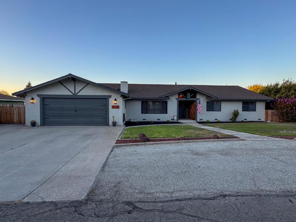 Walk into warmth and beauty. Located in one of the most desirable neighborhoods, this spacious single-story home sits on a generous 16,000+ sq ft lot and is filled with natural light throughout. Featuring an open yet cozy floor plan, this 4-bedroom, 2.5-bath residence is perfect for both everyday living and entertaining. Enjoy a 3-car tandem finished garage with epoxy floors and a bonus workshop - ideal for your hobbies, gym, or extra storage. The new kitchen is a showstopper, complete with a skylight over a large island, enormous walk-in pantry, and all-new appliances. A galley-style laundry room with built-in cabinetry and an extra utility room adds both functionality and convenience. Step outside to find mature landscaping including a persimmon tree, vibrant rose bushes, garden spaces, and ample room to create your backyard oasis - with scenic views of the nearby hills. Additional highlights: New interior and exterior paint, New flooring and baseboards, Updated primary bathroom with new vanity and floors, Finished garage, Ample guest parking with extra-wide and long driveway with separate gravel front area. This charming, one-of-a-kind home offers space, style, and serenity. Call your Realtor today or reach out for your showing! *PROFESSIONAL PHOTOS UP BY 8/7/25*