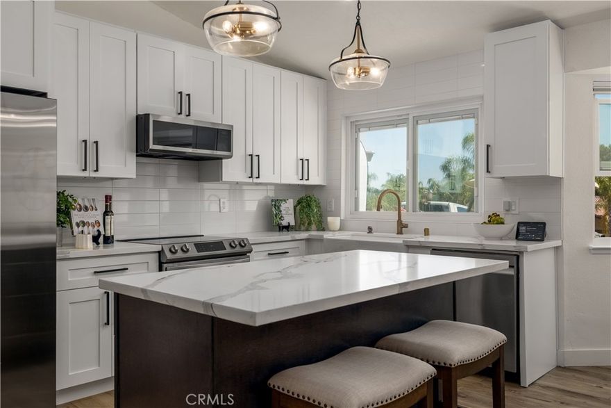 Welcome to your Canyon Lake retreat! This beautifully remodeled single-story home offers 3 bedrooms and 2 full bathrooms, perfectly blending modern upgrades with everyday comfort. Step inside to find luxury vinyl flooring throughout and a fully redesigned kitchen with quartz island, self-closing cabinetry, and newer appliances—ideal for both cooking and entertaining. The open-concept layout connects the kitchen, dining, and living areas, flowing seamlessly to a covered patio with views of the lush, low-maintenance two-tier backyard. Both bathrooms have been completely renovated, including a spa-inspired primary suite with a bidet, frameless glass shower with multiple water jets, and the convenience of a tankless water heater. Ceiling fans in all bedrooms add comfort year-round. Outdoors, a blooming wisteria shades the upper patio—a peaceful nook for morning coffee or evening gatherings. Fruit-bearing avocado, tangerine, and pear trees bring a touch of orchard living right to your door. As part of the exclusive 24-hour guarded Canyon Lake community, residents enjoy access to a private lake, golf course, pool, clubhouse, tennis courts, pickleball courts, equestrian center, and more. This move-in-ready gem is where charm meets modern convenience—perfect for living, relaxing, and entertaining. You don't want to miss it!