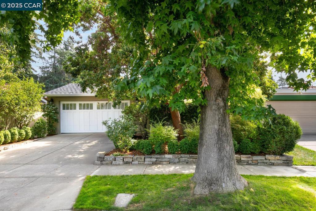 A serene sanctuary in the Pleasanton Valley neighborhood, this elegantly remodeled 2-bedroom, 2-bathroom single-level home is nestled on a magical tree-lined lot. Gorgeous hardwood floors flow seamlessly throughout the house, while custom molding and millwork in every room present a graceful and refined space. The open-concept kitchen features custom cabinetry, granite countertops, marble backsplash, Wolf range, Sub-Zero refrigerator, Bosch dishwasher, Bosch microwave, and Andersen windows that overlook the patio garden and backyard. Both bathrooms have been exquisitely remodeled with custom vanities, marble countertops, marble tile floors, high-end fixtures, and a deep soaking tub. The living room had a major remodel that raised the roof to create a vaulted ceiling. The addition of two skylights flood the space in natural light, creating a bright and airy environment. A spacious primary suite features an Andersen bay window, a custom window seat and access to the backyard. A second bedroom, used as an office, has custom built-in library cabinets and a custom light system. Enjoy the beauty and privacy of the front courtyard garden as well as easy access to the tranquil backyard, ideal for outdoor dining, entertaining guests, or just relaxing with a glass of wine. Other features