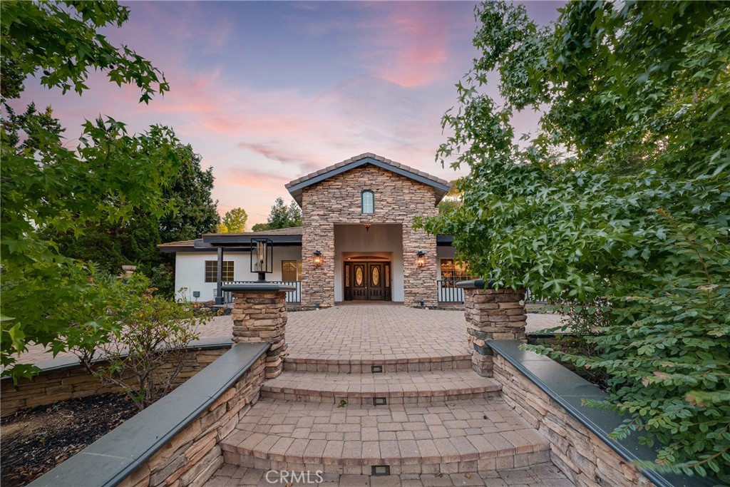 Exquisite Single Level Estate in Olinda Village with Breathtaking Canyon Views Discover the epitome of luxury living in this single-level estate, gracefully perched in the peaceful Olinda Village. Rebuilt in 2004, this home offers a blend of elegance and modern comfort, with its expansive great room that opens to breathtaking canyon views. The gourmet kitchen is a culinary dream, boasting a large island, farmhouse sink, and high-end appliances, including a double oven and warming drawer. The space extends into a grand dining area, complemented by a walk-in and butler’s pantry. The family room is perfect for cozy gatherings. The residence features a luxurious main bedroom suite with coffered ceilings, luxury wood flooring, and dual walk-in closets, leading to a backyard oasis through French doors. The ensuite bath promises a spa-like retreat with a jacuzzi tub and walk-in shower. Accompanying are four additional bedrooms with luxury wood flooring and unique bathroom amenities. Outside, the slate stone patio with an outdoor kitchen and lush garden provides a serene escape. The front porch, circular driveway, and elegant hardscaping add to the property’s allure. Set in a desirable community with top schools and no additional fees, this home is more than a residence—it’s a lifestyle. ***furniture removed**