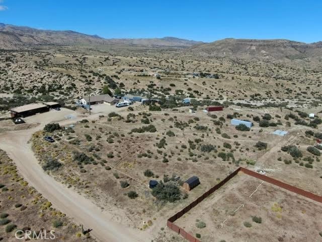 Appros 1./25 Acres gross. 2000 gal above ground water tank. 290' deep well approx 5 GPM. Utility shed. Addition public water available. Power pole on property.
360 Degree view. Lot is flat.