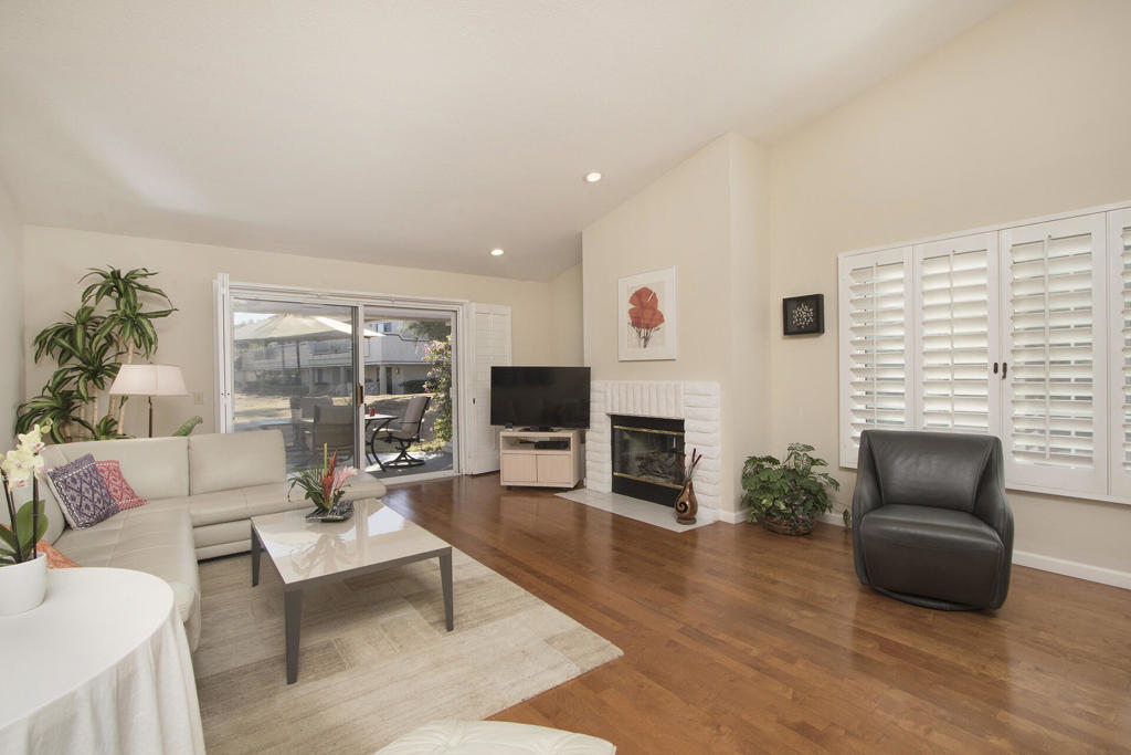 Sought after South-facing, single level, end unit! 2 Large bedrooms (formal dining could easily be converted back into a bedroom or den), 2 baths + powder room in 1,814 SF. Home has lovely, European-style contemporary kitchen, hardwood and tile floors, shutters, walk-in closets, high vaulted ceilings, entry courtyard, two car garage and more ... located on a large greenbelt with views of a sparkling pool! This one won't last!