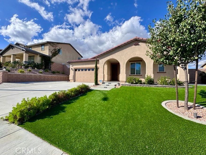 This 2021 built single-story home with solar is a gem waiting to be discovered and is located on a cul de sac in the Meadows community of Winchester. Approaching the home, you are greeted by a well-manicured lawn, ample parking, and great curb appeal. Coming inside, you'll immediately notice the open and spacious floor plan, creating a welcoming and airy atmosphere. The entire common area and secondary bedrooms are adorned with Luxury Vinyl Plank flooring, combining elegance with durability, while the primary bedroom offers plush carpeting. The heart of the home is the stunning kitchen, designed to impress, boasting shaker style cabinets, quartz countertops, stainless steel appliances, and a generously sized pantry to ensure you have plenty of storage space for all your culinary needs. The kitchen flows seamlessly into the living room and dining area, making it a perfect place to entertain family and friends. The dining area features a sliding door that leads to the backyard, allowing for easy access to outdoor gatherings and fresh air. The primary bedroom is large with an abundance of natural lighting and has an attached bathroom, featuring a walk-in shower and a separate soaking tub, dual sinks, and a spacious walk-in closet for all your wardrobe needs. Laundry can be found directly across from the primary bedroom. The secondary bedrooms are well-proportioned, and two of them boast walk-in closets, providing ample storage. The third bedroom offers a closet with sliding doors. This home also offers a versatile den with a closet! The guest bathrooms are equipped with a shower and tub combination, one offers dual sinks while the other offers a single sink. The garage is not only spacious enough to accommodate two vehicles but also features built-in storage, helping you keep your belongings organized and is equipped with a Tesla charger, making it an excellent feature for electric vehicle owners! Heading outside to the backyard, you are greeted by an oasis of relaxation. The combination of concrete and artificial grass creates a low-maintenance and visually appealing landscape, plant and tree maintenance is INCLUDED. A covered patio area provides shade on sunny days, making it a perfect spot for outdoor dining or simply enjoying the breathtaking views of the surrounding mountains. Additionally, this home features a premium water softener, drinking water filtration AND alkaline system! Conveniently located near the 215 fwy, shopping, dining and more!