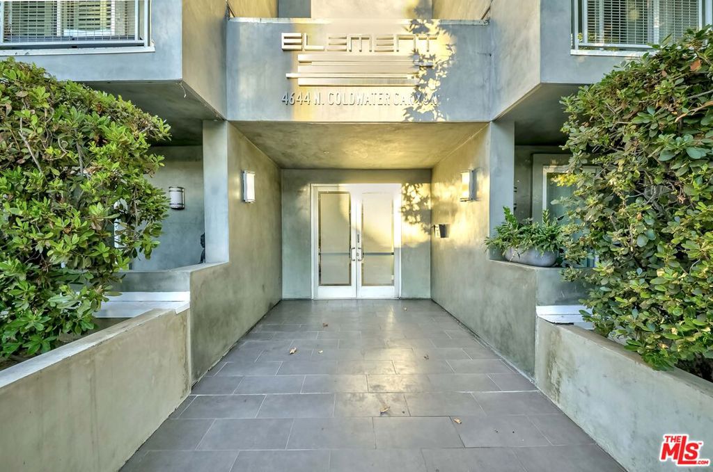 Experience sophisticated urban living in this stunning, light-filled penthouse perched on the top floor. This spacious, single-level residence offers 3 generously sized bedrooms, 2 full bathrooms, plus a convenient powder room, spanning an impressive 1,850 sq ft. Highlights include elegant wood flooring, custom built-ins, soaring ceilings, and walls of windows that flood the space with natural light. The gourmet kitchen is a chef's dream, featuring Caesarstone countertops, mosaic tile backsplash, and sleek stainless steel appliances. Enjoy a full-sized laundry room and energy-efficient tankless water heater for modern convenience. Step out onto the beautiful balcony to savor breathtaking views of the San Gabriel Mountains. The luxurious master suite boasts a custom-designed, expansive walk-in closet perfect for any wardrobe and a spa-like bathroom retreat. Additional storage is available on the same floor, and the unit's prime location adjacent to the elevator provides easy access, as do the reserved parking spaces. Meticulously maintained and showcasing a clean, contemporary architectural style, this exceptional penthouse effortlessly combines elegance and comfort for a truly elevated lifestyle.