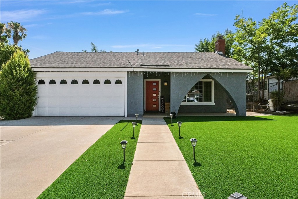 Welcome to your dream home in the heart of South Corona! This beautifully remodeled single-story residence features 4 spacious bedrooms and 2 modern bathrooms, thoughtfully upgraded with comfort and style in mind. From the moment you step inside, you're greeted by an elegant formal dining room complete with a cozy fireplace and neutral bamboo flooring—perfect for entertaining or relaxing evenings at home. The kitchen is a chef’s delight, showcasing granite countertops, a stunning mosaic glass backsplash, crisp white cabinetry, and stainless steel appliances. Both bathrooms have been tastefully updated with granite countertops and custom tile work, one of which includes a jet tub! The primary suite has been expanded with a permitted addition, offering extra space and direct access through a sliding door to your private backyard oasis. The front and backyard are designed for easy maintenance, featuring newer pet proof artificial turf and mature fruit trees. Enjoy peaceful evenings under the covered patio—ideal for those crisp fall nights. Located just minutes from the Foothill Corridor and the 15/91 Freeways, commuting is quick and convenient. Not to mention John Adams Elementary School is within walking distance. This home also boasts low taxes and a $150/month HOA that includes access to a community pool, pickleball courts, and multiple parks nearby. Don't miss your chance to own this truly turnkey home. Schedule your private showing today!