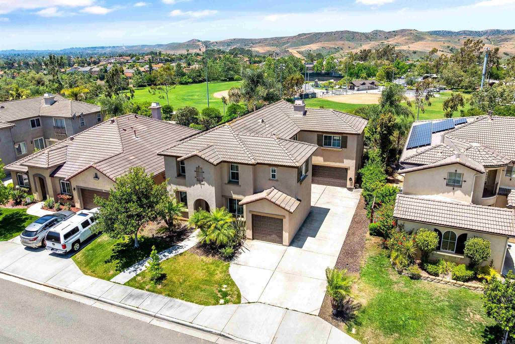 FULLY OWNED SOLAR + TESLA CHARGER | NO FRONT OR REAR NEIGHBORS | AMAZING OPPORTUNITY! Welcome to one of North County’s most sought-after communities—Arrowood! This is your chance to get in at the best price point and add instant equity with just a little fresh paint and TLC. This home checks all the boxes: energy efficiency, privacy, and flexible living in a resort-style setting. Highlights include a fully owned solar system, Tesla charger, and a whole-house copper re-pipe (2020)—all providing peace of mind and lower utility bills. The oversized 2-car garage, plus a third pass-through single garage, is a dream for any homeowner with epoxy floors, built-in storage, and insulated doors. Inside, you’ll find 5 bedrooms, 2 bonus rooms, and 4.5 baths spread across a spacious two-story layout. The heart of the home is the open-concept great room with a cozy den featuring a gas fireplace and 8-foot sliders that lead to the landscaped backyard with stamped concrete patio—perfect for indoor-outdoor living. The kitchen is designed for both function and style, with abundant storage, expansive prep space, a butler’s pantry/coffee nook, and a casual dining area. Upstairs, the primary suite offers a spa-like retreat with dual vanities, soaking tub, walk-in shower, and large walk-in closet. Two secondary bedrooms each feature ensuite baths, while another bedroom, full hall bath, office, and laundry room complete the level. Downstairs, enjoy formal living and dining rooms, plus a versatile bonus room that can serve as a guest bedroom, office, or playroom, along with a convenient half bath. Extra parking, no neighbors in front or behind, and a sense of privacy make this home truly special. Arrowood residents enjoy a low $150/month HOA, which includes a resort-style pool, spa, parks, playground, BBQs, walking trails, and a championship golf course designed by Ted Robinson Jr. Conveniently located minutes to the San Luis Rey Gate, Hwy 76, Luiseño Park, and within the Bonsall Unified School District. ? Don’t miss this chance to make Arrowood your home!