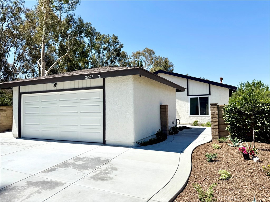 Welcome to 27502 Los Banos—a beautifully remodeled single-story home for lease on a picturesque corner lot in Mission Viejo. This 3-bedroom, 2-bath residence has been thoughtfully upgraded throughout, offering modern comfort and effortless style. Step into a bright interior featuring brand-new vinyl plank flooring, a fully updated kitchen with new cabinets and countertops, and fresh paint inside and out. Brand-new windows and doors enhance energy efficiency, while the new central heating and air conditioning system ensures year-round comfort. A full repipe of the home adds peace of mind, and the detached two-car garage offers abundant storage and an in-garage laundry area for added convenience.
Outside, enjoy a newly poured concrete driveway and patio, low-maintenance landscaping, and a spacious backyard shaded by mature citrus trees and surrounded by greenery. Set on a quiet corner lot with beautiful trees and extra privacy, this home is located in a well-established neighborhood near parks, schools, and Lake Mission Viejo. With its blend of upgrades, charm, and location, this rental is a rare opportunity in one of South Orange County’s most desirable communities.
Listing agent is owner. New stainless appliances have been ordered, photo of appliances was digitally generated.