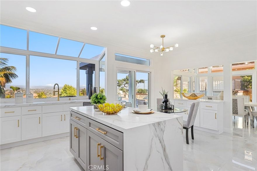 Discover unparalleled coastal living in this meticulously renovated 3-bedroom, 2.5-bathroom home nestled within the prestigious Niguel Summit community of Laguna Niguel. Spanning 2088 square feet, this stunning residence boasts panoramic vistas stretching from Saddleback Mountain to the Pacific Ocean. Step inside to discover a beautifully redesigned interior featuring a cozy fireplace in the family room, complemented by chic lighting fixtures. Just upgraded with new windows, doors, and fresh paint, along with gorgeous porcelain tile floors, the home exudes modern elegance and comfort. The gourmet kitchen is a culinary delight, showcasing quartz countertops, sleek white shaker cabinets adorned with gold hardware, an eat-at island with stylish grey cabinets, and state-of-the-art appliances including a wine fridge. Luxury awaits in the primary suite, complete with a spacious walk-in closet, a sumptuous soaking tub, a separate step-in shower, and dual sinks overlooking scenic vistas. Ideal for entertaining, the newly surfaced pool with a tranquil jacuzzi and water feature beckons relaxation amidst breathtaking views. Additional highlights include two secondary bedrooms with updated glass slider closets, an updated hall bath with a large skylight-lit step-in shower, and luxury vinyl flooring throughout the upstairs for a touch of refinement. Enjoy the ultimate in privacy with a front gated courtyard entry and the convenience of direct access to a 2-car garage and a 2-car driveway. Located on a single loaded street, this home offers serenity and exclusivity in one of Laguna Niguel's most coveted neighborhoods. Perfectly positioned near Monarch Beach, Dana Point Harbor, and the vibrant cultural scene of Laguna Beach, residents will relish easy access to world-class beaches, renowned hiking trails, golf courses, and upscale shopping and dining options. With top-rated schools nearby, this is an exceptional opportunity to experience Southern California coastal living at its finest.