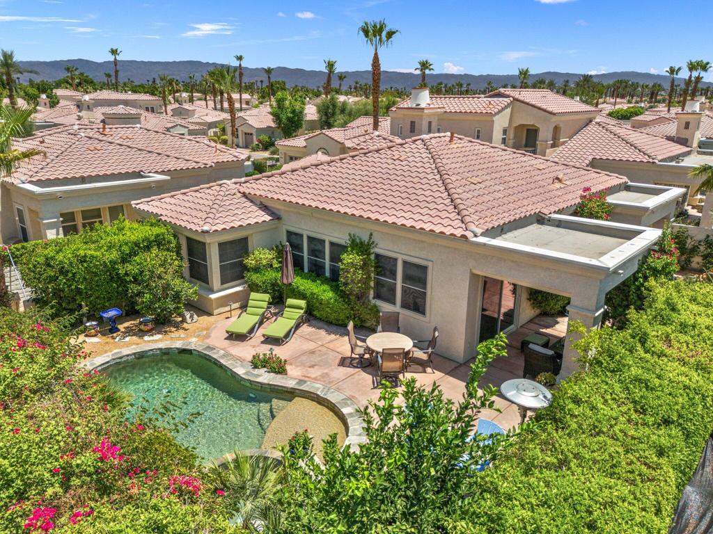 Effortlessly stylish and filled with sunshine, this south-facing, turnkey furnished Hacienda in Puerta Azul offers unobstructed mountain views, a private pool & spa, fire pit, ultimate privacy, and coveted short-term rental eligibility. Set in one of the community's prime locations, this 2BD/2.5BA (1,557 SF) residence enjoys all-day natural light perfect for laid-back desert living or investment versatility.Inside, the vibe is crisp and contemporary with high ceilings, abundant windows, and a layout designed for both comfort and separation. Two spacious primary suites, each with dual vanities, are positioned on opposite ends of the home--ideal for hosting guests in style. The open kitchen is equally functional and inviting, featuring granite slab counters, stainless steel appliances, bar seating, and a dreamy sink view.An airy dining area opens to the outdoors through glass sliders, extending your living space to a large wrap-around patio. Whether you're sipping coffee in the sun or lounging beneath the covered patio, the lush landscaping--dotted with blooming flowers and citrus trees--sets the tone for relaxation.Included in the lower monthly HOA's is access and use of the fitness center, a tennis court, community pools and spas and the club house. Whether you're exploring your first desert escape, seeking an income-generating opportunity, or completing a 1031 exchange, this turnkey home delivers on every front.