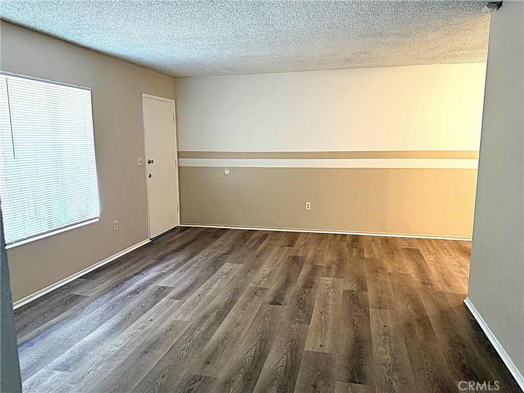 Upgraded condo is available for lease in the city of Orange. This corner unit (418) is located upstairs and features two bedrooms and two full bathrooms, with new upgrades throughout. The unit includes new waterproof laminate flooring, fresh paint, new carpet, and newer recessed lighting.
The open-concept design highlights an oversized living room that seamlessly flows into the dining room and connects to a galley-style kitchen equipped with a four-burner gas stove and plenty of counter space. The living room also has a wall air conditioning unit to keep you cool during the summer months. Down the hallway, you will find a spacious quest bathroom with a shower/tub combo. Just outside the guest bathroom, there is a wall of storage cabinets and a hall closet for your convenience. Each of the two bedrooms includes deep closets with overhead storage. This condo provides a washer and dryer area for tenant use. This unit also features a one-car detached garage with a storage closet, as well as a shared driveway that is wide enough for all tenants to easily enter, exit, and park in their own private one-car garage. The detached garage door includes a man door for easy access. Water, trash, and gas are included in the occupancy fee. Don’t miss out on this must-see unit—schedule a visit before it’s gone!