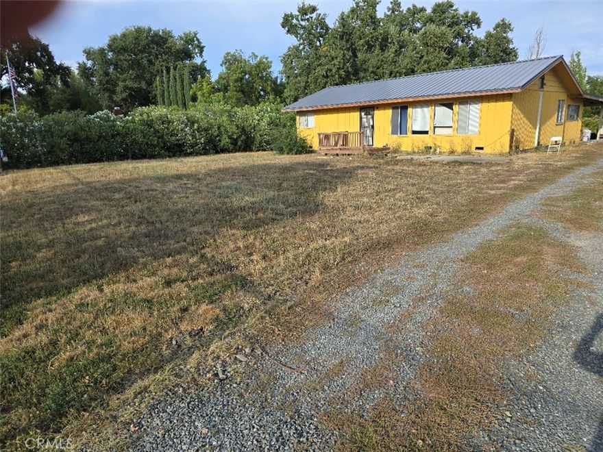 CHANNEL FRONT home, 2 BD/1 BA, in south Lakeport, with sizable bedrooms and a spacious living room, a laundry room, and a large family/ general-purpose room on an extra large, mostly-fenced, level lot (nearly 6/10 acre). This property has a good well and a septic system--so no water or sewer bills! Behind the home, there's a carport and an RV Parking space with sewage and water hookups.  Owner just installed a new metal roof. Also installed fairly recently are 3 mini-split heating/ A/C units. The septic tank was replaced about 4 years ago. There's a storage shed in the back of the lot and, in the front of the lot, there's a stick-built structure that could be a storage unit or a workshop.