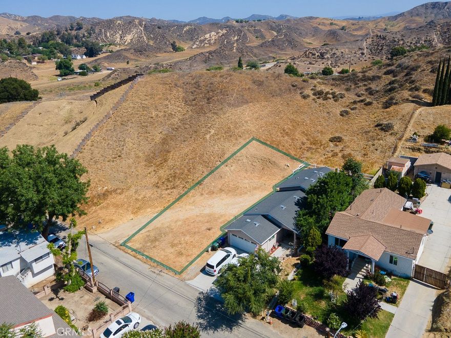 Don’t miss this incredible opportunity to own a prime piece of land in the peaceful community of Val Verde! Nestled at the edge of a residential neighborhood, this lot offers beautiful views of the surrounding hills and open space. The property has already been surveyed, saving you time as you plan your build. With established single-family homes on both sides, utilities nearby, and easy access via a paved road, this lot is a ready-to-go canvas for your dream home or investment project. Located near amenities in nearby Castaic and Valencia—including grocery stores, restaurants, shopping, and more—this property combines the best of rural charm with suburban convenience.