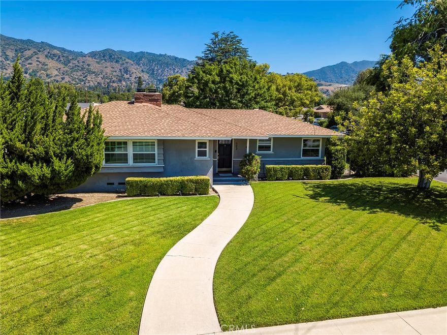 Find your tranquil retreat in this charming mid-century home, tucked away on a safe and peaceful corner lot. Ready for you to move in and start making memories, this residence immediately welcomes you with its bright and airy feel. The spacious living room, bathed in natural light and hardwood flooring throughout, provides the perfect setting for cozy evenings or lively gatherings.  Step into a kitchen that truly celebrates its heritage! This delightful mid-century kitchen is a nostalgic dream, featuring original wood cabinetry that exudes timeless warmth. You'll appreciate the classic appeal of tile countertops and the distinct character of the decorative mid-century laminated flooring. A charming built-in bench creates a cozy eating nook, perfect for casual meals and morning coffee, inviting you to savor the unique ambiance of this bygone era. This charming home offers three comfortable bedrooms, including one bedroom with its own en-suite bathroom. Two additional bedrooms provide flexibility for family, guests, or a dedicated home office. Step outside to truly appreciate the expansive lot – an exceptional feature providing ample space for outdoor activities, gardening, or the potential for an addition or Accessory Dwelling Unit (ADU). (Buyers to verify ADU regulations with the City). Located in a sought-after neighborhood renowned for its top-rated schools, this property ensures access to excellent educational opportunities for your family. This isn't just a house; it's the ideal place to create lasting memories.