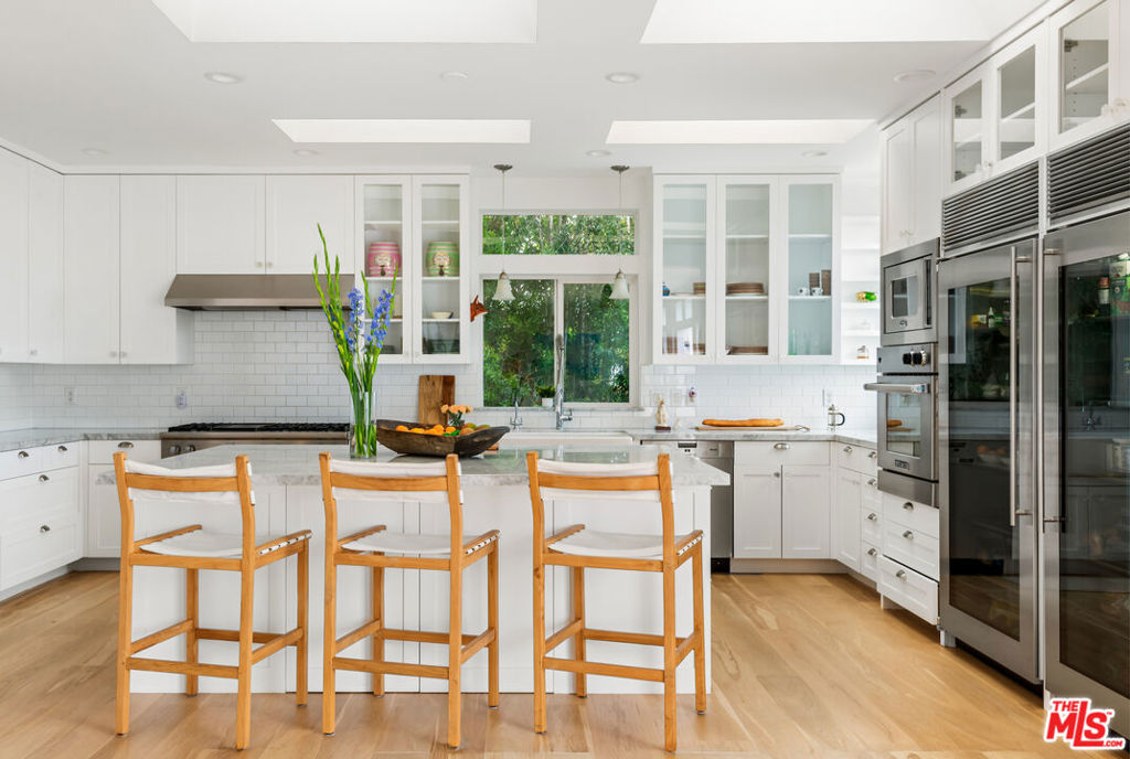 Tucked behind 24-hour guarded gates in one of Malibu's most iconic communities, this rare oversized property in the coveted Point Dume Club stands out as one of the largest in the neighborhood. Set within a secure, resort-style enclave, residents enjoy access to a pool, sauna, tennis and basketball courts, a playground, a dirt bike trail, and a double-gated private path leading directly to the sands of Zuma Beach. This four-bedroom, newer construction main residence is designed thoughtfully and elegantly for effortless coastal living. A professional chef-built gourmet kitchen anchors the home, featuring Miele and Viking appliances, dual refrigerators, and a large walk-in pantry. A separate den offers flexible living space, while an outdoor shower and custom surfboard storage add to the relaxed and polished beach lifestyle. Ample private parking for four plus vehicles adds convenience, while the upscale, tight-knit community reminds you of a Malibu that's nearly impossible to find anymore. Timeless, welcoming, and just steps from the ocean. This is the quintessential Malibu home designed with the surf minded- laid back luxury that defines living on the Point.