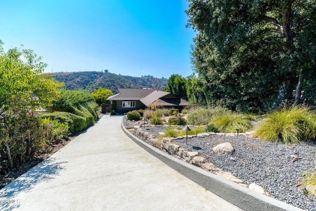 Tucked into a quiet hillside street, this home offers beautiful views that stretch over the Jet Propulsion Laboratory and the San Gabriel Valley. This well-cared-for home features warm hardwood floors, great natural light, and an easy-flowing floor plan that connects the main living and dining areas. The kitchen includes granite countertops, double ovens, and a central island--ideal for everyday use or casual hosting. Large windows throughout the home bring in light and showcase the expansive views. The backyard has been updated with drought-tolerant landscaping, offering a low-maintenance space to relax, garden, or take in the sunset. Located close to trailheads, parks, and Altadena's local shops and cafes, the home sits in a peaceful neighborhood with a strong sense of community. A great option for anyone looking for comfort, quiet, and views in the foothills.