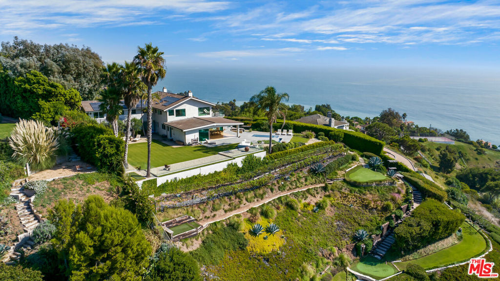 California dreaming. Stunning contemporary home with walls of glass that look out to staggering panoramic ocean views from Santa Monica to Point Dume and beyond. Chic open floor plan with sophisticated finishes. Gracious primary suite with two very large walk-in closets and balcony jutting out to the ocean views. Gated, and sited on over 2 acres of manicured grounds with 5 hole par 3 golf course, organic vegetable gardens and vineyards. Pool surrounded by romantic lounge area with fire pit and large grassy yard. Beach and tennis rights at Malibu La Costa Beach Club. Quintessential Malibu living at its finest.