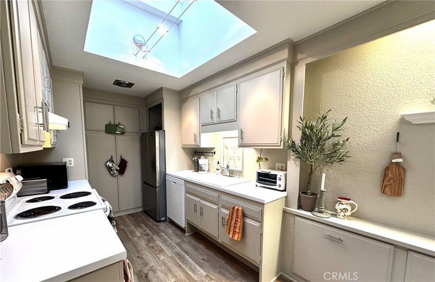 Avail Jan1 - Located in the prestigious LW Gated community with 24 hour security this popular 1BR Coronado floorplan is the upper one which has no steps and no one above. It has modern upgrades such as new kitchen skylight, low maintenance vinyl planking flooring both rooms, dual pane windows and slider, smooth ceilings and designer paint colors. The sun filled kitchen is thoughtfully designed with raised counters for both style and practicality. Bathroom with convenient walkin shower and new vanity. HVAC high efficiency offers year round heating and cooling comfort. AC/Heat in bedroom too. Key takeaways are no one living above you, a very large balcony offering greenbelt views with a great breeze and natural air and light flow. This home also provides the convenience of no-step access to the carport, and laundry facilities, ensuring easy mobility.Carport just steps away to front door.  Added bonus to this location is that it is within walking distance to Clubhouse 4 ARTS Center and pool .Cremaics, sculpture,  Located within a vibrant 55+ community, this remodeled residence combines comfort and modern living. This is an amazing home in one of Laguna Wood's premium areas! Laguna Woods Village residents enjoy a 27-hole championship Golf course, a 9-hole executive par 3 course, Pickleball and Tennis courts, Gyms, Clubhouses with 200 clubs such as the Comedy Club and Performance Arts Theater. Horse stables and Saddleback Emeritus College Art programs with world class Art facilities is same Gate 5. Take advantage of this opportunity to enjoy an exiting lifestyle with all the amenities and services that Laguna Woods has to offer.