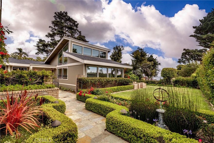 Discover this private, island-inspired sanctuary just minutes from the coast. This beautifully refreshed 2-bedroom, 2-bath home offers a serene escape with lush landscaping, multiple slate patios, and a tranquil courtyard that evokes the feeling of Hawaii. Enjoy peekaboo ocean views from your own backyard oasis.

Inside, fresh interior paint and a reimagined stacked stone fireplace create a welcoming and modern ambiance. The updated guest bath adds a contemporary touch, while bamboo flooring flows through the kitchen and dining areas. The kitchen features a uniquely shaped island. Each room overlooks the patios and grounds creating a sense of true indoor-outdoor living. Vaulted ceilings enhance the open, airy feel, and a flexible bonus space Could easily be converted to a3rd bedroom, or use as home office or creative studio.

Additional highlights include a 2-car garage with EV charger and plenty of storage. This one-of-a-kind property blends relaxed coastal living with style, a functionality and privacy. A must see!