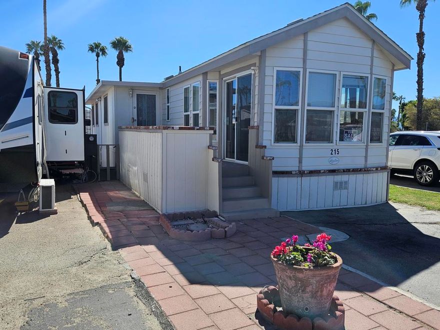 Located in the desirable Indian Wells RV Resort, this well-kept park model offers two bedrooms, one full bath, a comfortable living room, a functional kitchen, and a convenient storage shed. The community provides a full range of amenities, including free WiFi, cable TV access, a mail center, recycling areas, restrooms and showers, pet area, swimming pool, hot tub, basketball and shuffleboard courts, fitness center, biking paths, game room, library, on-site laundry facilities ($), and ice availability ($). Situated in a prime location close to Home Depot, Costco, and local shopping, this property offers outstanding value and convenience in the heart of the desert.