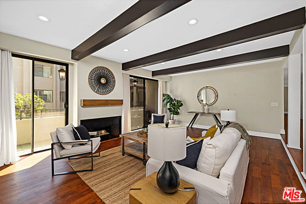 Discover the perfect blend of charm and modern comfort in one of West Hollywood's largest single level condominiums! A tranquil retreat just moments from the iconic Sunset Strip, this residence offers nearly 2,000 square feet of updated living space that is perfectly designed for both everyday living and effortless entertaining. Step through double doors into a bright and airy sunken living room where dual sliding doors frame the fireplace and open to a private balcony. The entertainment space flows seamlessly into a formal dining room and kitchen featuring an additional breakfast nook and wine fridge. Down the hall, you will find three comfortable bedrooms and bathrooms, including an expansive primary suite that boasts two large walk-in closets and a spa inspired bath with dual vanities. Natural light fills the home from windows on both sides, and with only one shared wall (kitchen), privacy is maximized. Enjoy resort style living with every convenience at your fingertips: in-unit laundry, same floor side-by-side parking, private storage room, abundant guest parking, and building amenities including a pool, multiple jacuzzis, saunas, lounge areas, fitness center, pool room, and clubhouse.Thoughtful upgrades include a new HVAC system (2024), smart thermostat, recessed lighting, an updated electrical panel, along with numerous enhancements since 2021. HOA dues cover amenities, water, sewer, trash, building maintenance, and earthquake insurance. This is an exceptional property in an unbeatable location, just moments from the very best shopping, dining, and entertainment West Hollywood has to offer.