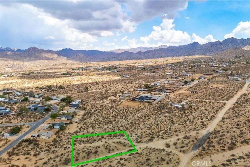 If you've been looking for a great plot of land to build your desert dream home, look no further than this stunning .28 acre parcel in the heart of Joshua Tree Village. Conveniently located just minutes from the main entrance to Joshua Tree National Park, this lot already has PUBLIC WATER, making building your ideal getaway that much easier to bring into reality. As you approach the lot, you'll appreciate that it is only a stone's throw from the pavement, making access a breeze. Despite being so close to all the amenities of both Joshua Tree and the town of Yucca Valley, this lot enjoys lovely views of the rugged mountains of Joshua Tree National Park that rise dramatically along the southern horizon. The best part is that with over a quarter of an acre of land, you'll have a generous amount of space to work with in a great central location. Lots this close to all that Joshua Tree has to offer can be rare and difficult to find, particularly with this much space, so don't pass up your opportunity to check out this beauty for yourself. (The address is fictitious and used as marketing purpose. APN: 0602-341-21-0000)