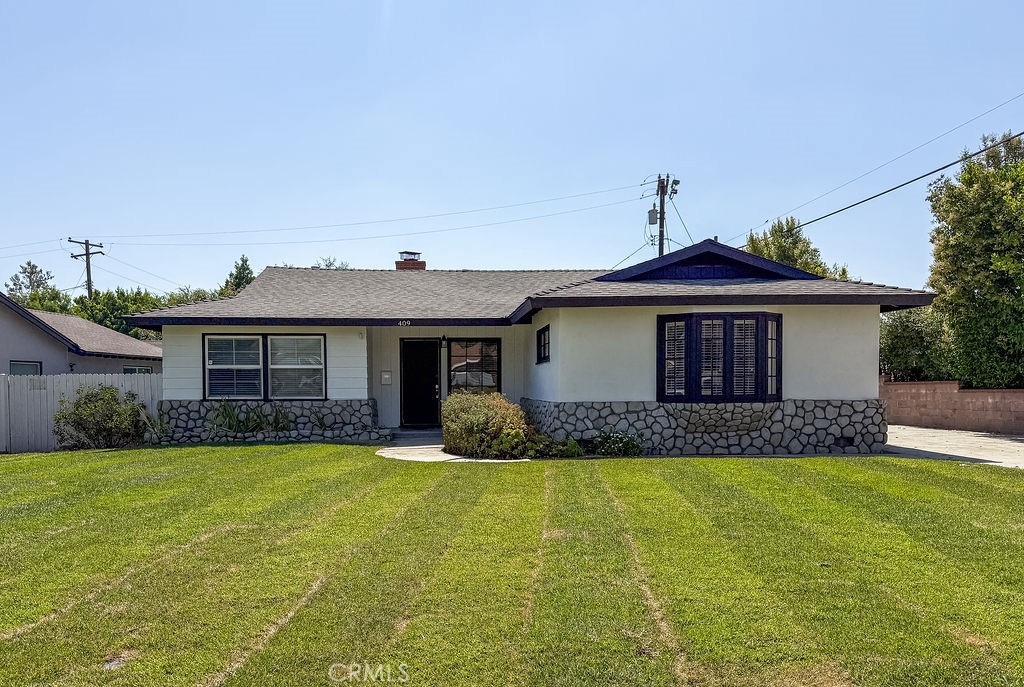 Welcome to 409 N Elwood Ave in Glendora! This beautifully updated 4-bedroom, 2-bath home features fresh interior and exterior paint, new carpet throughout, and stylish new hardware in the kitchen. The spacious living room flows into a well-appointed kitchen with a center island, newer cabinets, countertops, and appliances—perfect for cooking and entertaining. Enjoy cozy evenings by the fireplace in the family room. Additional highlights include indoor laundry, a detached two-car garage with a long driveway, and a lovely backyard with a covered patio, ideal for outdoor relaxation. A move-in-ready gem in a great location!