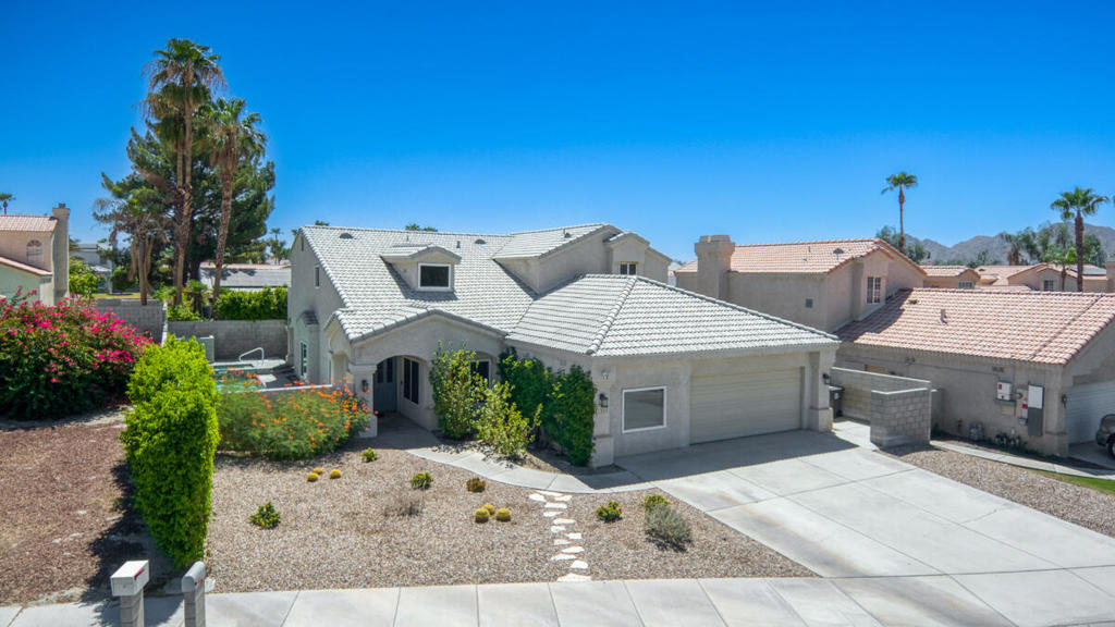 Located in a highly desirable Primrose neighborhood with no HOA. This beautiful family home has 4 bedrooms and 3 full bathrooms with a private in-ground saltwater pool and spa and front yard desert landscaping. Enter through double doors into a formal entry with a wood featured wall and an open floor plan offering a formal living room with vaulted ceilings, formal dining area, gourmet kitchen with granite slab counters and stainless steel appliances. There's breakfast bar seating opening into a large family room with a fireplace and built-in wet bar with granite counter, 2 built-in desk areas, a bedroom with ensuite bathroom and a laundry room that completes the main floor. Upstairs you will find 3 more bedrooms including a massive primary suite with fireplace, a walk-in shower, soaking tub, and His and Hers walk-in closets and a wrap-around balcony with panoramic mountain views. There are 2 more bedrooms that also access the balcony and there is a full size hall bathroom for the secondary bedrooms to share. This home also features plantation shutters throughout, french doors, ceiling fans, dual A/C, Wainscoting, recessed lighting, an attached 2-car garage with electric car plug-in, and a bonus room in the garage. The private back yard has a gated saltwater pool and spa, side yard with covered patio, artificial turf and cement area -- this is a perfect space for entertaining. Schedule your private tour today. Mortgage savings may be available for buyers of this listing.