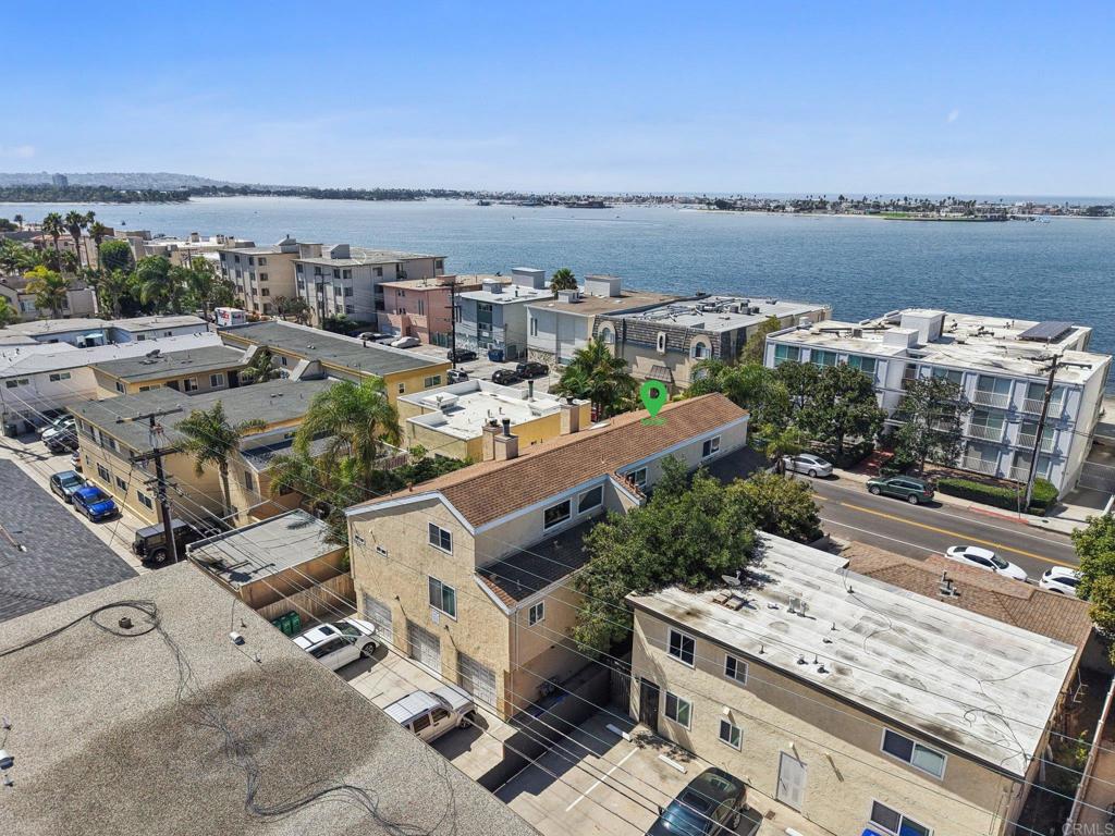 Just what you were looking for, steps from the Bay! Beautifully updated condo in the desirable Crown Point neighborhood of Pacific Beach. This spacious home features an open floor plan with vaulted ceilings, hardwood floors, and abundant natural light. The kitchen features granite countertops, stainless steel appliances, and crisp white cabinetry, complemented by a breakfast bar that flows seamlessly into the dining and living areas—ideal for both everyday living and entertaining. Two bedrooms on the main level, each with its own full bathroom, provide versatility for family, guests, or a home office. Upstairs, a spacious loft-style third room offers endless possibilities, whether as a media room, gym, or private workspace. Enjoy your morning coffee on the private balcony, relax in the bright living room, or take advantage of being walking distance from Mission Bay and Crown Point Park. Additional highlights include in-unit washer/dryer, modern fixtures, a garage and assigned parking space. Conveniently located near top schools, dining, shopping, and the vibrant coastal lifestyle of San Diego, this property is ideal as a primary residence or vacation retreat.