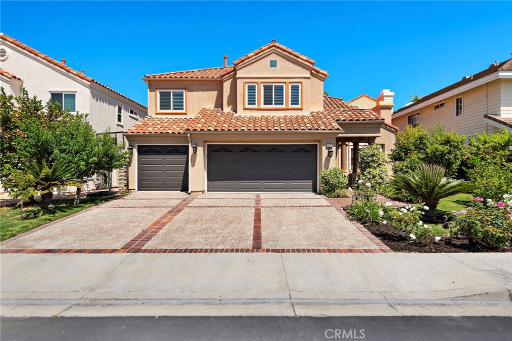 PROPERTY JUST UNDERWENT MAJOR RENOVATIONS TO CONVERT BONUS ROOM INTO SECOND PRIMARY SUITE WITH FULL EN-SUITE BATH! New flooring upstairs! Set in the coveted, guard-gated community of Canyon Crest, this highly upgraded home offers an open floorplan and amenities perfect for entertaining. As you enter the property through the wrought iron front door you are greeted by soaring ceilings and an elegant chandelier. High ceilings in the living room and dining area provide an open airy feeling and a main floor bedroom (currently converted to an office) as well as an upgraded main floor full-bath provide added comfort and functionality. The modern, upgraded kitchen is the focal point of the home. A quartz waterfall island and breakfast bar provide tons of space for dining and cooking. Lighting fixtures and backsplash provide sophistication and new appliances throughout the kitchen top it all off. A conveniently located pantry ensures that you will never run out of space. The kitchen seamlessly transitions to the family room, providing a perfect area to gather. Around the corner you will find a sleek wet bar equipped with a wine refrigerator. Upstairs, you will find the spacious primary suite with a long balcony to relax on. A fireplace, walk-in closet and updated primary bath provide a resort-like experience. Down the hall you will find two Jack and Jill bedrooms with an upgraded full bath shared between the two of them. At the end of the hall you will find the new en-suite bedroom, providing comfort and functionality. Downstairs, the home boasts a 3-car garage and a spacious laundry room with room for side by side Washer and Dryer, as well as tons of cabinets for storage. Outside you will find a hardscaped backyard with a built in barbecue island, fireplace and waterfall. The backyard and front yard are adorned with beautiful fruit trees producing a wide variety of fruits. The property underwent ADDITIONAL UPGRADES in 2023-2024 including brand new Milgard doors/windows, the home was repiped, new AC, new whole home water filtration system, new chandelier, new appliances and MUCH MORE! The 24 hour guard-gated community of Canyon Crest boasts endless amenities including 4 pools, spa, clubhouse, fitness center, tennis and racketball courts, playground, basketball court, BBQ area and much more! The home is located a short distance from Lake Mission Viejo, dining and other amenities.