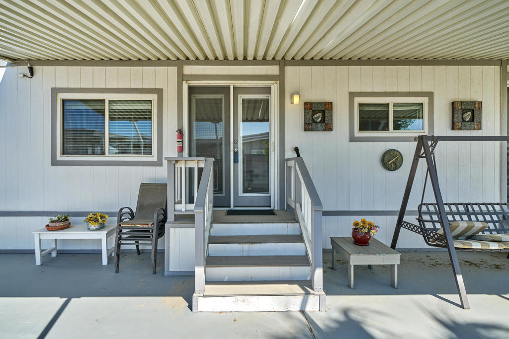 Enjoy the ideal desert lifestyle in this charming 2-bedroom, 2-bathroom, 1,344-square-foot home located in the desirable 55+ Tri-Palm Estates & Country Club. This move-in ready double-wide manufactured home is situated in a fantastic location within the community. The home features a remodeled kitchen, dual-pane windows, and updated flooring, providing a comfortable and modern living space.This home offers plenty of outdoor space to relax and enjoy the beautiful desert weather, views of the golf course pond, including an expanded private patio with a water feature. The property also includes sheds for extra storage and comes with a golf cart, making it easy to enjoy all the amenities the community has to offer.