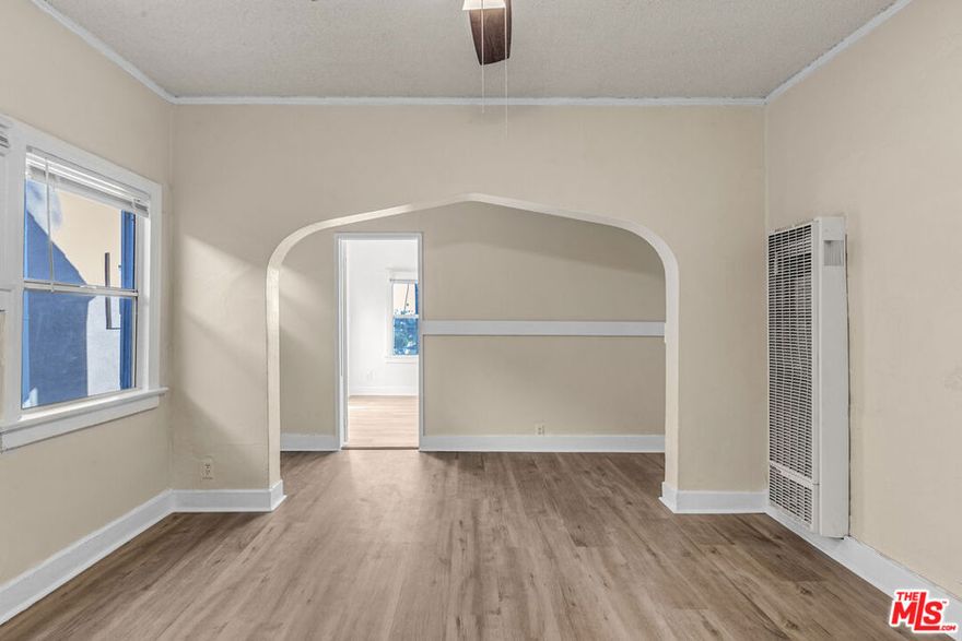 Step into this light-filled top-floor three-bedroom, one-bath apartment in the heart of Jefferson Park. Vintage charm runs throughout the home, from the arched entryways to the original details and hardwood floors that stretch across the entire space. The living room feels open and welcoming, perfect for kicking back or hosting a few friends. The galley-style kitchen pairs natural wood cabinetry with generous counter space, creating a functional spot for everything from laid-back brunches to busy weeknight dinners. Each of the three bedrooms gets great light and comes equipped with a ceiling fan for added comfort. The front bedroom opens onto a shared balcony, where you can take in truly stunning views, an unexpected bonus you'll look forward to daily. The vintage-style bathroom continues the character-forward vibe, while thoughtful touches throughout give the home personality and warmth. One assigned parking space is included, and yes, pets are welcome! On-site laundry isn't currently available, but we've heard that may be changing soon. With easy access to the 10 Freeway, Downtown LA, Culver City, and Mid-City, this centrally located gem sits in one of LA's most walkable and historic neighborhoods. It's a great spot to call home, and a rare one at that!