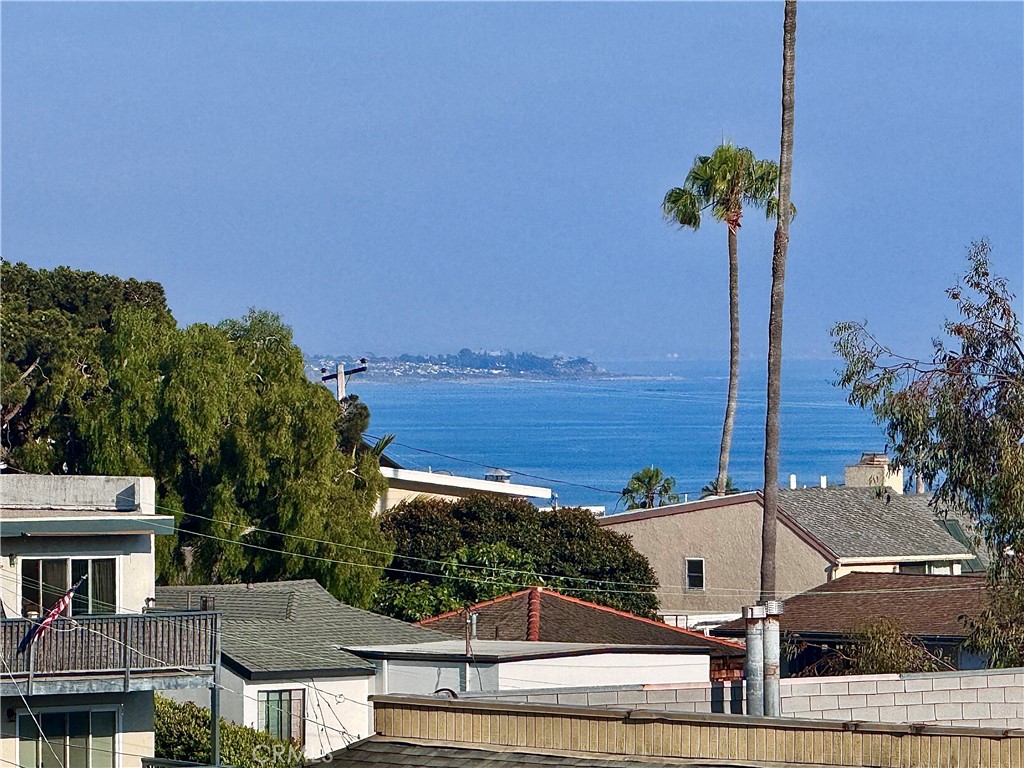 Completely remodeled with ocean views! Experience coastal living at its finest in this beautifully remodeled, turnkey townhome nestled in the heart of Dana Point. Spanning 1,387 square feet, this 2-bedroom, 2.5-bath residence has been thoughtfully redesigned from top to bottom with modern finishes and designer touches throughout. The reversed floorplan features the main living areas upstairs, where a bright and open layout showcases new luxury vinyl plank flooring, a completely remodeled kitchen, and expansive windows that frame tranquil ocean views. Downstairs, you’ll find two generously sized bedrooms, including a luxurious primary suite with a stylish en-suite bath and private access to downstairs patio. The secondary bedroom also has en suite bathroom with stylish tiled walls and new vanity and quartz countertops. Located near the bedrooms is a conveniently located in-unit laundry room. Every inch of this home has been upgraded, including a brand-new AC system for year-round comfort. The newly tiled bathrooms, sleek fixtures, and contemporary cabinetry elevate the overall aesthetic, blending comfort with sophistication. This unit has already been repiped with PEX piping as well. Ideally located just minutes from Dana Point’s beaches, harbor, restaurants, and shops, this turnkey townhome offers a rare opportunity to own a stylish coastal retreat ready for immediate enjoyment.