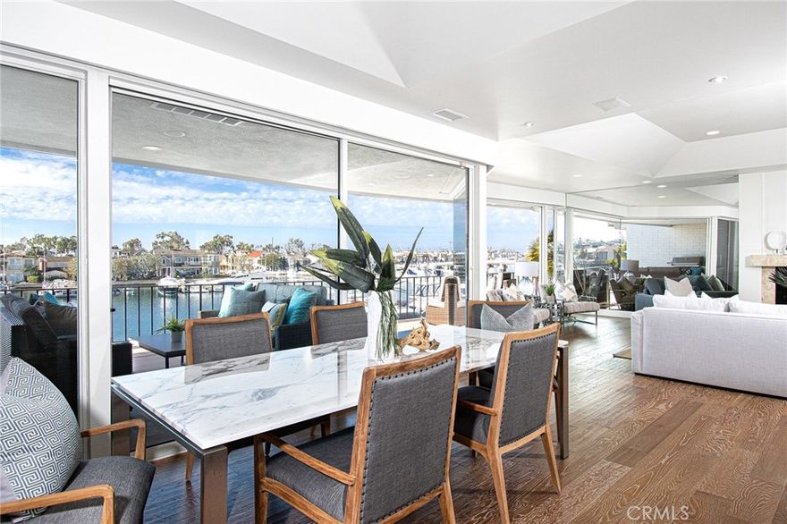 Rarely Available, this beautifully remodeled soft contemporary Bayfront home is located in a highly desired community facing Little Balboa Island. Two large bedrooms plus a generous living room/dining/kitchen area were expanded to take advantage of the amazing water views. The expanded Primary Bedroom and Bath Suite with walk-in closet are a luxury. Views from the living areas and newly surfaced deck include the ocean, harbor, and famous bridge access to Balboa Island and jetty - with all the action of the boats coming in and going out- as well as the crewers and SUP athletes. This property is a top unit, single level, that has no boats parked in front to obstruct the 180 degree view. The kitchen will entice anyone to cook, with top-of-the line appliances along with Carrara marble counter tops and backsplash behind the sink reaching to the ceiling. New Air Conditioning, all lighting converted to comfortable LED, life-source filtered water, and new awnings. Come see this fabulous opportunity to live on the water with the bonus of front row seats to the famous Christmas Boat Parade and Fourth of July fireworks! Walking distance to Balboa Island, beaches, restaurants and shopping.